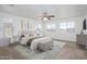 Airy main bedroom with carpet, a ceiling fan, and an abundance of natural light from multiple windows at 3361 E Wisteria Pl, Chandler, AZ 85286