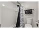 Bright bathroom features a shower with a floral-patterned curtain and black hardware at 3825 E Camelback Rd # 290, Phoenix, AZ 85018