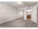Bedroom features carpet, a ceiling fan, and mirrored closet doors leading to the bathroom at 3825 E Camelback Rd # 290, Phoenix, AZ 85018