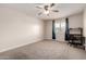 Bedroom featuring neutral carpeting, a ceiling fan, and a corner desk setup at 3825 E Camelback Rd # 290, Phoenix, AZ 85018