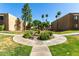 Serene courtyard with a decorative fountain, manicured greenery, and community walkway at 3825 E Camelback Rd # 290, Phoenix, AZ 85018