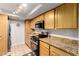 Kitchen featuring stainless steel appliances, granite countertops, and wooden cabinetry at 3825 E Camelback Rd # 290, Phoenix, AZ 85018