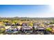 Residential aerial of community featuring desert landscape and mountain views and many homes with pools and spas at 40619 N Candlewyck Ln, Phoenix, AZ 85086