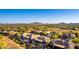 Community aerial showcasing desert landscape, mountain views, and homes with pools, desert landscaping, and covered patios at 40619 N Candlewyck Ln, Phoenix, AZ 85086