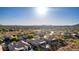 Desert community aerial view with houses featuring pools, desert landscaping, covered patios, golf course, and mountain views at 40619 N Candlewyck Ln, Phoenix, AZ 85086