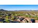 Scenic aerial view of a community with golf course and mountain views at 40619 N Candlewyck Ln, Phoenix, AZ 85086