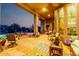 Spacious back patio with ample seating, beautiful landscaping, a sparkling pool, and charming outdoor decor at 40619 N Candlewyck Ln, Phoenix, AZ 85086