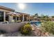 Backyard with pool, patio, desert landscaping, dining and lounge areas, under sunny blue skies at 40619 N Candlewyck Ln, Phoenix, AZ 85086