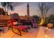 Backyard patio with built-in fireplace, seating and desert landscaping for relaxed outdoor living and entertaining at 40619 N Candlewyck Ln, Phoenix, AZ 85086