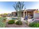 Stunning backyard features a pool with rock features, covered patio, desert landscaping, and inviting lounge area at 40619 N Candlewyck Ln, Phoenix, AZ 85086