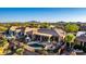 Aerial view of an outdoor oasis featuring a pool, covered patio, seating, lush landscaping, desert and mountain views at 40619 N Candlewyck Ln, Phoenix, AZ 85086