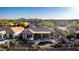 Aerial view of backyard with pool, covered patio, outdoor seating, well-manicured desert landscape, in a luxury community at 40619 N Candlewyck Ln, Phoenix, AZ 85086