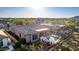 Backyard aerial view showcasing a pristine pool, covered patio, grill, desert landscaping, and mountain views at 40619 N Candlewyck Ln, Phoenix, AZ 85086