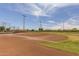 Baseball field with clay infield and green grass under a blue sky at 40619 N Candlewyck Ln, Phoenix, AZ 85086