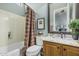 Well-lit bathroom features a shower-tub combination, stylish vanity with granite countertop, and neutral wall color at 40619 N Candlewyck Ln, Phoenix, AZ 85086