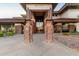 Welcoming clubhouse entrance with stone columns and decorative lighting, signaling a vibrant community center at 40619 N Candlewyck Ln, Phoenix, AZ 85086