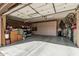 Spacious three-car garage with built-in storage cabinets and ample room for vehicles and storage at 40619 N Candlewyck Ln, Phoenix, AZ 85086