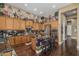 Spacious kitchen with custom cabinetry, black marble countertops, stainless steel appliances, and a cozy breakfast bar at 40619 N Candlewyck Ln, Phoenix, AZ 85086