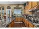 Bright kitchen featuring custom cabinetry, black marble countertops, stainless steel appliances, and scenic outdoor views at 40619 N Candlewyck Ln, Phoenix, AZ 85086