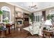Inviting living room featuring hardwood floors, a fireplace, and plenty of natural light at 40619 N Candlewyck Ln, Phoenix, AZ 85086