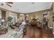 Open-concept living room with hardwood floors, large windows, and elegant furniture arrangement at 40619 N Candlewyck Ln, Phoenix, AZ 85086