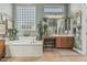 Bright bathroom with a soaking tub, dual vanity, and elegant fixtures, perfect for relaxation and comfort at 40619 N Candlewyck Ln, Phoenix, AZ 85086