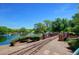 Scenic pond view with walking paths and bridge at 40619 N Candlewyck Ln, Phoenix, AZ 85086