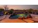 Inviting backyard pool with rock waterfall, desert landscaping, and mountain views creates a serene outdoor space at 40619 N Candlewyck Ln, Phoenix, AZ 85086