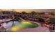 Inviting backyard pool with rock waterfall, desert landscaping, and mountain views creates a serene outdoor space at 40619 N Candlewyck Ln, Phoenix, AZ 85086