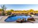 Beautiful backyard pool with rock waterfall feature and desert views in a private setting at 40619 N Candlewyck Ln, Phoenix, AZ 85086