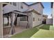 Home's backyard featuring a patio, gazebo and artificial turf at 4332 E Boston St, Gilbert, AZ 85295