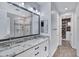 A dual-sink bathroom vanity with modern fixtures, granite countertops, and sleek cabinetry at 4332 E Boston St, Gilbert, AZ 85295