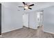 A bright bedroom space with wood-look floors and access to a bathroom and closet space at 4332 E Boston St, Gilbert, AZ 85295
