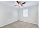 Empty bedroom with light walls, neutral carpet, ceiling fan, and a single window at 4332 E Boston St, Gilbert, AZ 85295