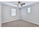 A basic bedroom with neutral carpet, light walls, a ceiling fan and window at 4332 E Boston St, Gilbert, AZ 85295
