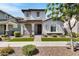 Charming two-story home showcasing a well-manicured lawn, inviting entry, and detailed architectural features at 4332 E Boston St, Gilbert, AZ 85295