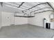 Spacious garage featuring painted walls, storage racks, and epoxy flooring at 4332 E Boston St, Gilbert, AZ 85295