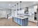 Bright kitchen with island, white cabinets, subway tile backsplash and staircase in background at 4332 E Boston St, Gilbert, AZ 85295