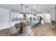 Inviting kitchen and dining area with white cabinets, a central island, and stylish pendant lighting at 4332 E Boston St, Gilbert, AZ 85295