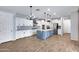 Open kitchen boasts stainless steel appliances, large blue island and light wood floors at 4332 E Boston St, Gilbert, AZ 85295