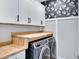 Well-organized laundry room with wood countertops, cabinets and modern washer and dryer at 4332 E Boston St, Gilbert, AZ 85295