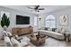 Cozy living room featuring modern furniture, a ceiling fan, and a large window for natural light at 4332 E Boston St, Gilbert, AZ 85295