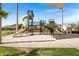 A colorful community playground with slides, climbing structures, and a sandy play area for  at 4332 E Boston St, Gilbert, AZ 85295