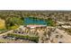 Overhead view featuring a community clubhouse and a scenic lake surrounded by lush golf course and parking at 4502 W Continental Dr, Glendale, AZ 85308
