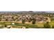 Expansive aerial view showcasing the neighborhood, golf course, and mountain views in the distance, illustrating the area's landscape at 4502 W Continental Dr, Glendale, AZ 85308