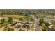 Stunning aerial view overlooking a golf course, a lake, and the community with mature trees and well-maintained landscaping at 4502 W Continental Dr, Glendale, AZ 85308