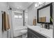 Bathroom highlighting modern vanity, shower and tub combination with white tile and updated fixtures at 4502 W Continental Dr, Glendale, AZ 85308