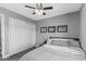 Bedroom featuring large closet, ceiling fan, framed photos, and neutral colors at 4502 W Continental Dr, Glendale, AZ 85308