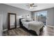 Serene bedroom featuring neutral tones, a modern ceiling fan, and sliding door access to outdoor patio at 4502 W Continental Dr, Glendale, AZ 85308