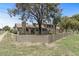 Exterior view of a well-maintained home with a fenced yard and mature trees at 4502 W Continental Dr, Glendale, AZ 85308